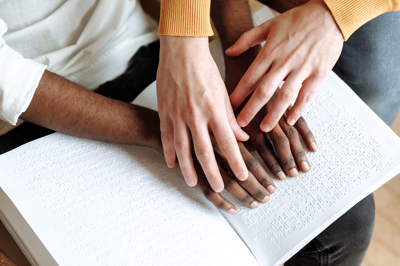 A Person Touching a Braille Book